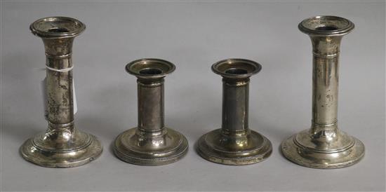 A pair of Victorian silver dwarf candlesticks and a later pair of silver candlesticks, tallest 14cm.